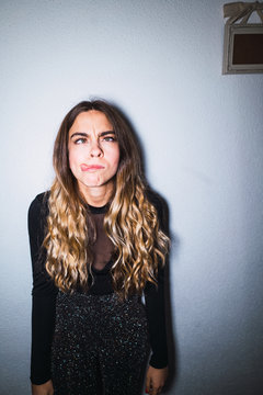 Expressive woman at wall