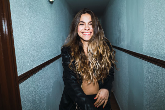 Cheerful woman posing in hall