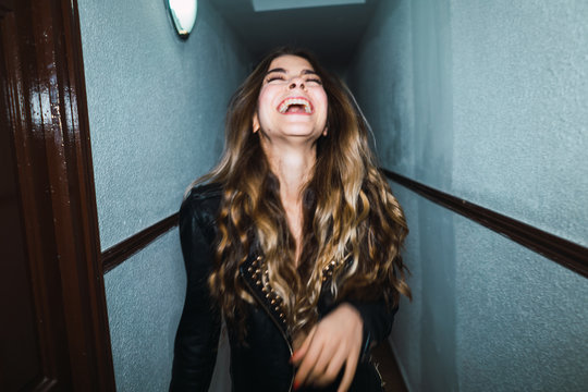 Cheerful woman posing in hall