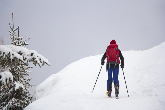 Man with skis walk by snow on the mountain