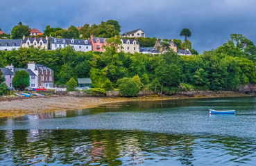 Fototapeta na wymiar Portree (Port Rìgh]), the a charming fishing harbor and the largest settlement on the Isle of Skye in the Inner Hebrides of Scotland.