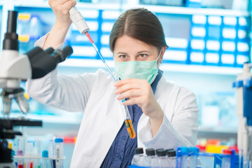 Girl laboratory assistant in the chemical laboratory of the university experiment with chemical...