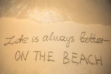 Life is always better On The Beach word is written on the beach sand
