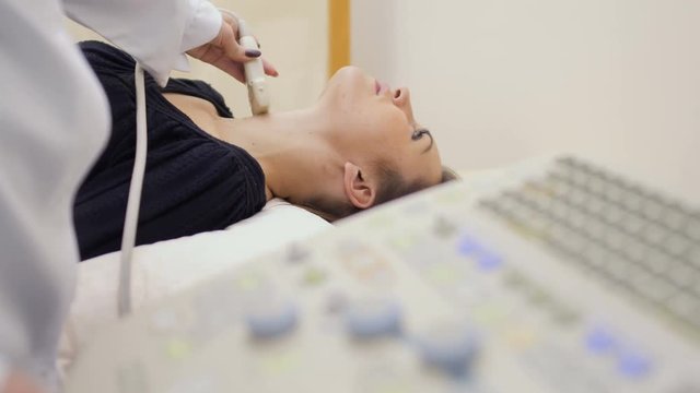 Doctor checks pathyroid and thyroid with ultrasound machine