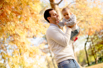 Fototapeta premium Young father and baby boy in autumn park