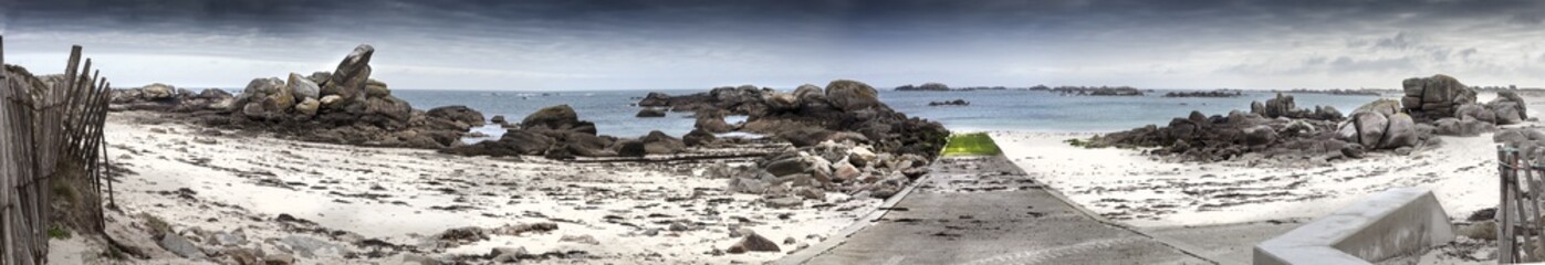 Fototapeta na wymiar Giant granite stones coastline in Brittany, France, panorama made from 6 images