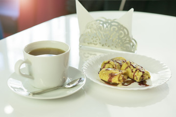  tasty traditional russian pancakes  with coffee cup on white table in the cafe for breakfast