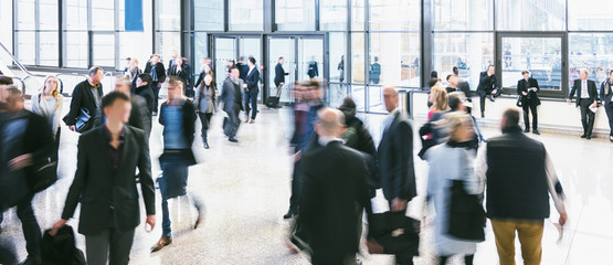 blurred people walking in a futuristic corridor