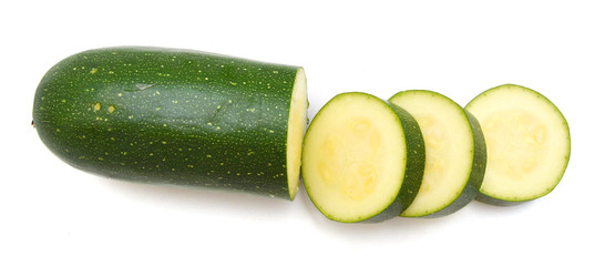 Cut courgette or zucchini on a white background