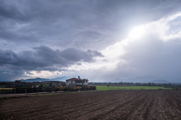 Fototapeta premium Farmland under Cloudy Sky