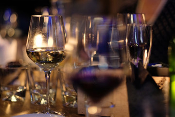 Glasses with white and red wine from thin glass on a table in a restaurant