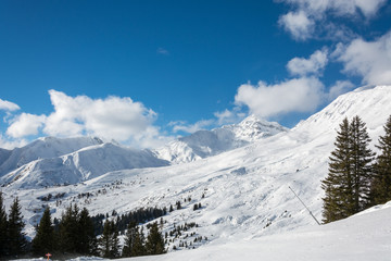 Fototapeta na wymiar Slope in ski resort Serfaus Fiss Ladis in Austria with snowy mountains