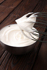 close up of a white whipped or sour cream in bowl