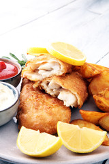 traditional British fish and chips with potato and lemon