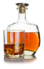 glass with cognac and ice, next bottle with cognac