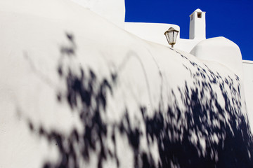 Foreshortening of Mykonos island, with the typical white construction and bouganvillea shadow, Cyclades islands Greece Europe.