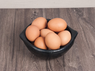 Brown eggs on wooden background
