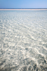 Fototapeta na wymiar The crystalline water of Elafonissi beach, a protected area in the south of Crete island, Mediterranean sea, Greece.