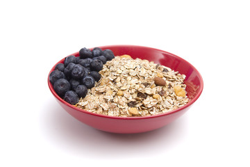 Healthy Breakfast of Organic Muesli and Fresh Blueberries in a Large Red Bowl