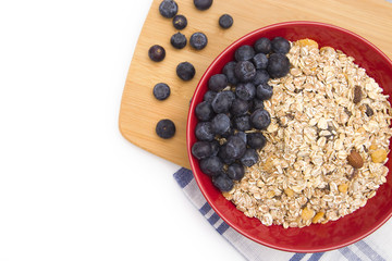 Healthy Breakfast of Organic Muesli and Fresh Blueberries in a Large Red Bowl