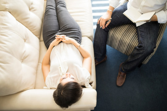 Top view of a patient lying on a sofa during psychotherapy session