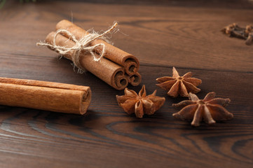 Cinnamon sticks and anise on a wooden background