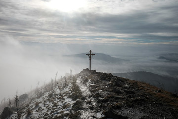 hilltop with a cross and sunshine in the winter - obrazy, fototapety, plakaty