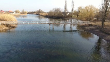 River eric current in the village in the spring. Shallow river, slowly flowing in the village.