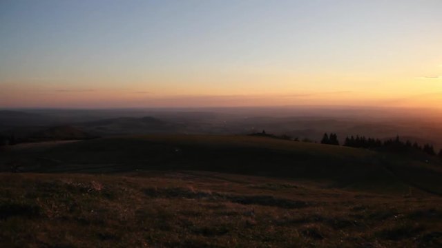 Distant sunset with smoth movement over german hills