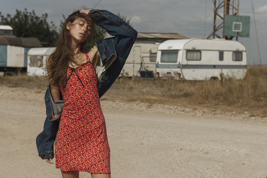Frustrated Caucasian woman standing near trailers