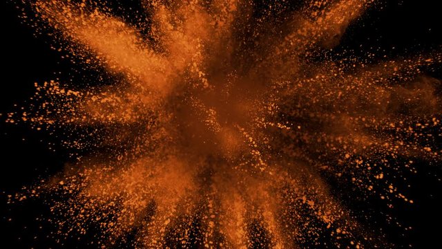 Orange powder exploding on black background in super slow motion, shot with Phantom Flex 4K
