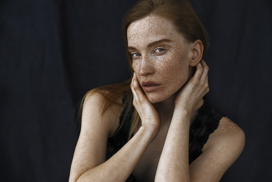 Portrait of young woman with freckles