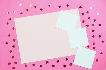 Paper pink background with empty notes. The concept of Valentine Day or bloggers. Flat Lay, top view