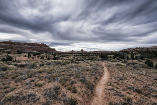 Clouds over desert path, Moab, Utah, United States