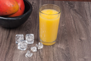 mango smoothie on the wooden background