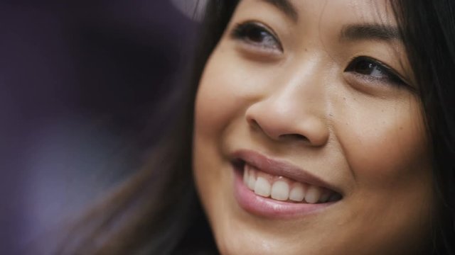 Close shot of young chinese female listening during a conversation