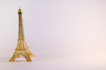 Eiffel Tower golden miniature on white background