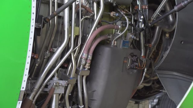Engine and chassis of the passenger airplane under heavy maintenance. Engineer checks the aircraft engine.