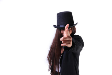 woman wearing a white tee shirt, suspenders and black bowler top hat shooting