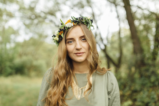 Middle Eastern woman wearing flower crown in woods