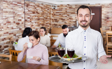 Fototapeta na wymiar Waiter serving restaurant guests
