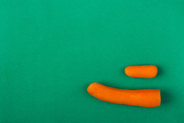 Two carrots,big and small,on green background