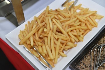 food, catering, self-service and eating concept - close up of french fries