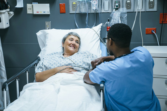 Nurse talking to patient in hospital bed