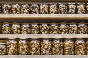 Porcini mushrooms marinated in glass jars in the local market in Ukraine