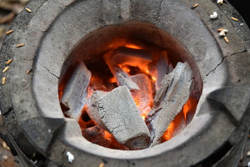 Hot fire of charcoal burning in the stove.Burning charcoal firewood in the stove, selective focus