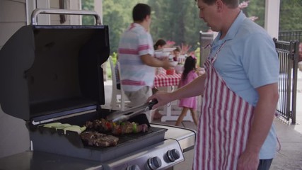 Serving food from grill at backyard barbeque - Powered by Adobe