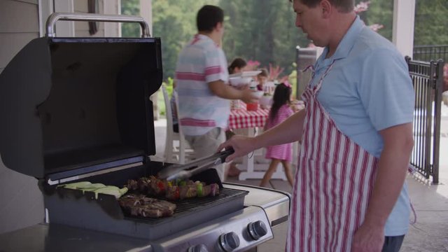 Serving food from grill at backyard barbeque