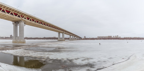 Fototapeta na wymiar Bridge over the frozen river Oka in Nizhny Novgorod, Russia