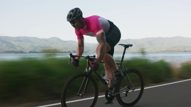Tracking shot of a male cyclist on country road.  Fully released for commercial use.